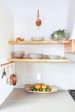 Easily navigate this chefs kitchen with open shelving.