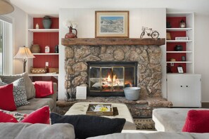 Wood Burning Fireplace with firewood provided.