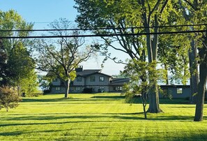 Exterior view of the home situated toward the back of the property