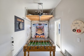 The garage is converted to a game room for your entertainment.