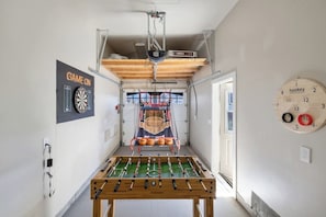 The garage is converted to a game room for your entertainment.