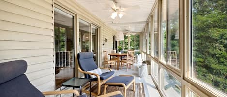 This is our favorite indoor-outdoor space with lounge seating & a game table.