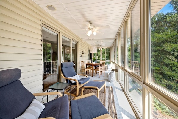 This is our favorite indoor-outdoor space with lounge seating & a game table.