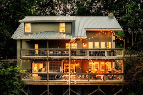 Back decks include a custom fire pit, hot tub, outdoor dining and plenty of comfortable seating!