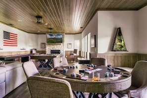 The ultimate game room with a pool table, poker table, shuffleboard, arcade game system and boss toss!