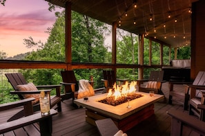 A large custom fire pit on the lower deck makes for the perfect spot to cozy up!