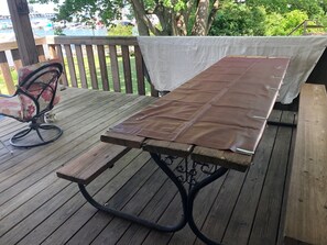 8 person picnic table on deck overlooking water
