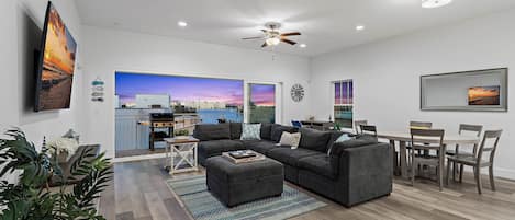 Panoramic water views with an oversized sliding glass door in the living room