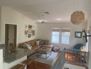 Living area/kitchen open concept with high ceilings.