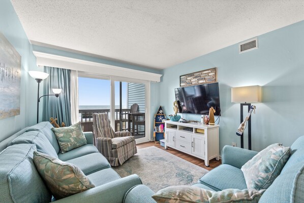 The ocean front living room is well-appointed with comfortable furnishings.