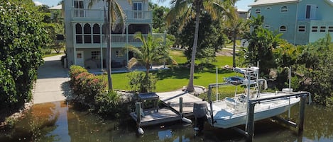 Back of house showing private boat ramp