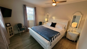Large room with TV and California King sized bed. Medium firm mattress.