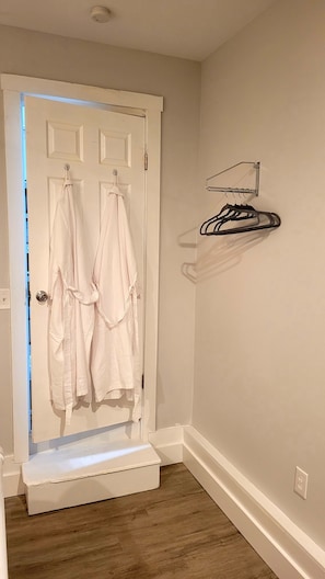 Two Robes in bedroom and space to hang clothes 