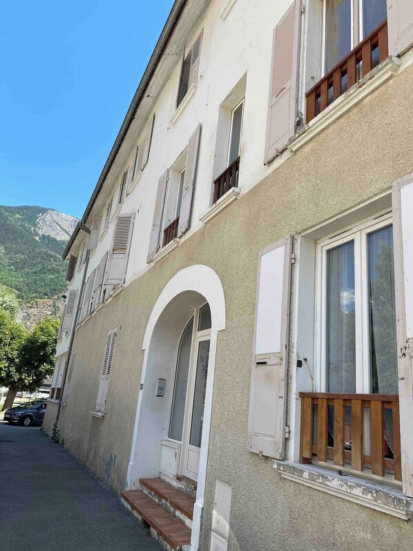 The apartment is on the first floor of this two story building and is situated beside the pretty rive running through town.