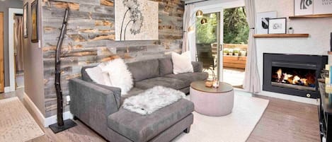 Cozy open concept living space with remote controlled gas fire place. 