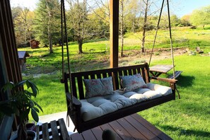 "Grandma's swing" on the side deck is a shady spot to take a breather.