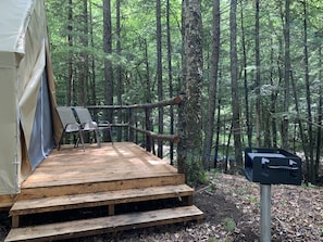 Brooke Ridge Glamping deck with fire pit and charcoal grill.