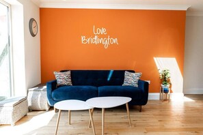 Instagram worthy wall with modern blue sofa