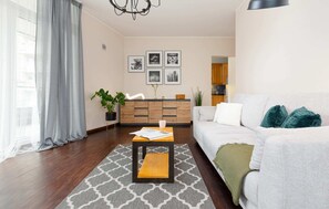 A minimalist living room with neutral-toned furniture and natural light pouring in through the windows.