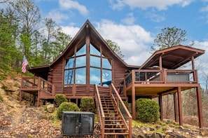 Front exterior of our Scenic Hideaway cabin showcasing deck expansion. (photo taken in winter)