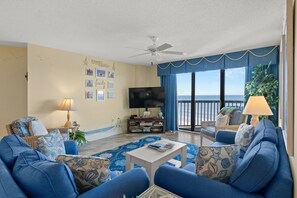 Relax in the comfort of a large well-appointed living room with an ocean view.