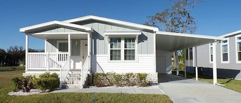 Front view.  Storage shed at end of long carport.  