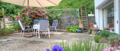 Flower, Plant, Property, Flowerpot, Chair, Umbrella, Botany, Table, Lighting, Petal