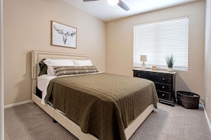 Another bedroom features a queen bed and clean and comfortable linens.