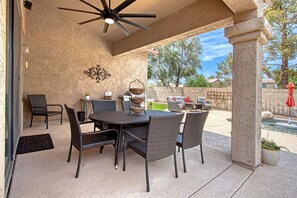 The patio with outdoor table and chairs near the pool