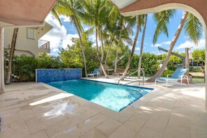 Relax by the pool in the shaded area, providing respite from the sun's rays.