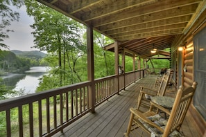 Relax on the porch with a beverage of choice at this pet-friendly cabin rental in North GA