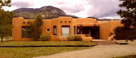 Exterior with mountain view background and short 15 minute drive to Taos Village, 35 ninute drive to Red River, NM