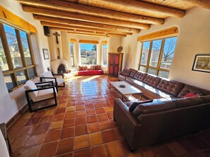 Sunken living room with 3 extra large window walls and mountain views