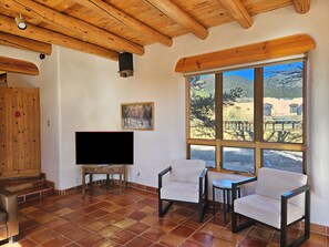 Living Room with large streaming flat screen TV and mountain views