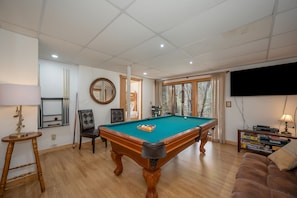 Lower level gameroom with pool table, games,TV and French Doors to lower deck

