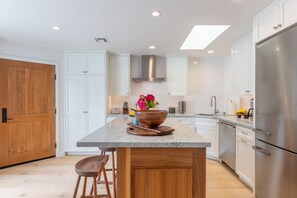 The kitchen features a center Carrara Marble Island. 