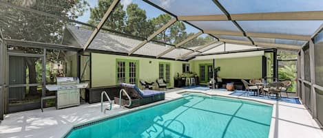 This private screened in pool area is the perfect spot for a weekend BBQ with family and friends.