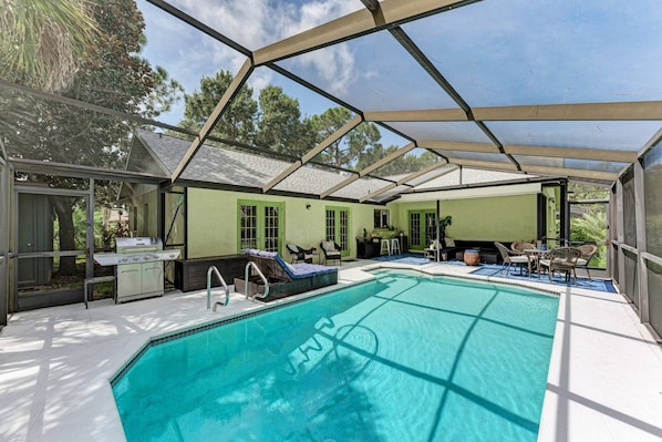 This private screened in pool area is the perfect spot for a weekend BBQ with family and friends.