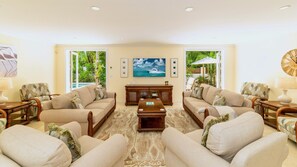 The living room features ample comfortable seating...