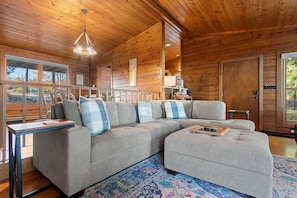 Greeting you in the living room is an inviting stone fireplace, cozy sofa, and two drink tables - perfect for kicking back with friends and family during your stay in Door County.
