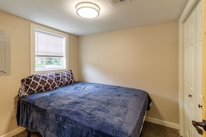 Bedroom 2 in rear of house with Queen bed.