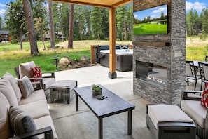 Freebird: - Fantastic covered, outdoor living space with a large TV, comfortable furniture, and a gas fireplace.