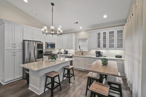 Beautiful modern kitchen with bar seating and dining table
