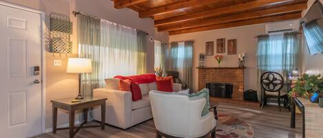 Wood beamed ceiling add style and warmth to this spacious living room.