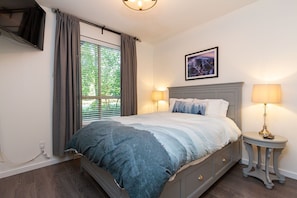 Master bedroom with queen bed and HD TV with great light