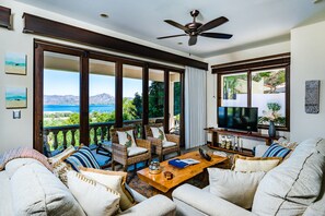 Living room with floor to ceiling accordion windows. 