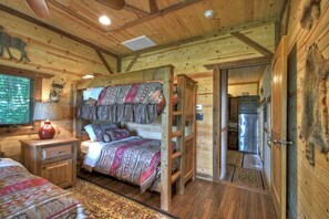 Bunk beds in bedroom with king size bed.