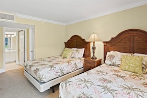 Spacious and comfortable master bedroom with two queen beds and flat screen TV