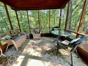 Covered & screened in back porch is perfect for relaxing