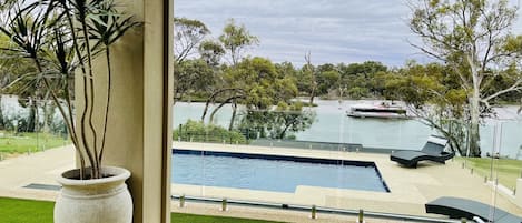 Heated swimming pool with Murray River views & glass panel fencing off alfresco